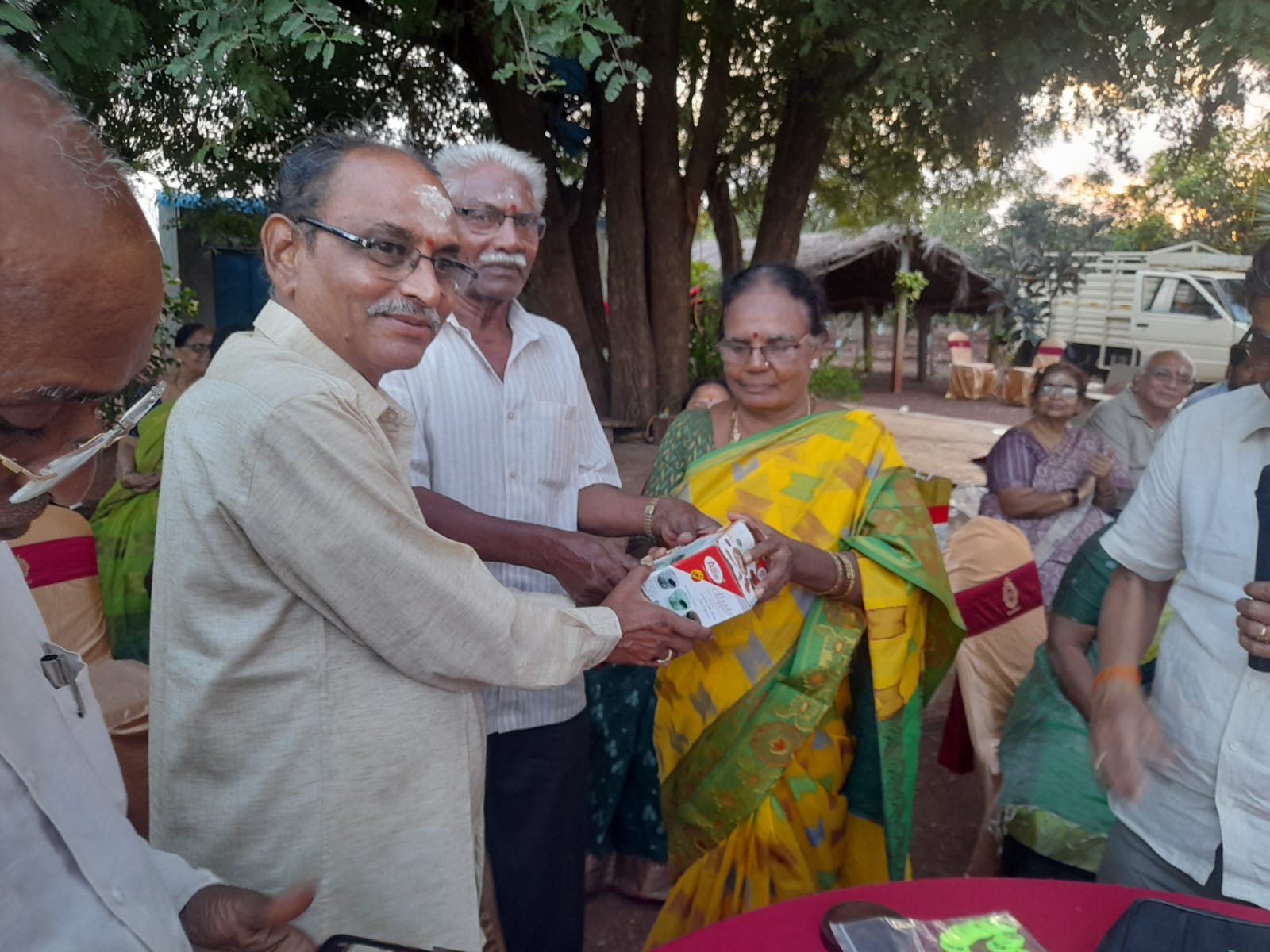 Smt. Renuka garu W/O Venkulu garu receiving First prize in Musical chair (Women) in  get-together party held on 22-11-2023.